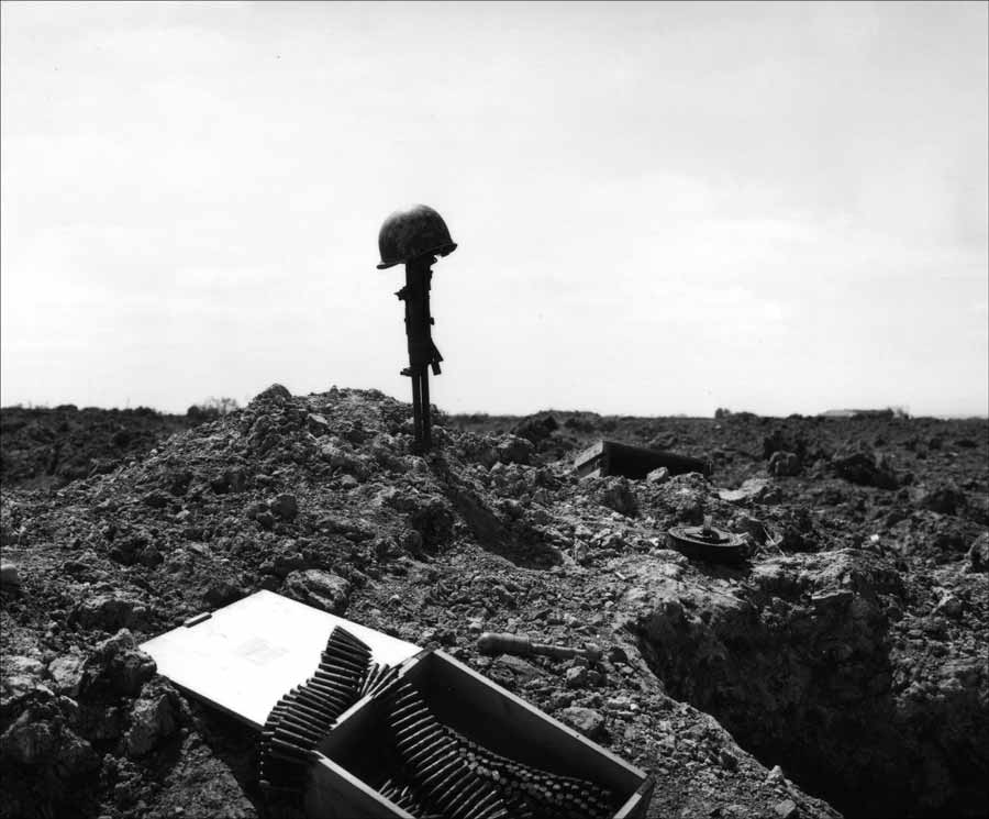 A US helmet sits atop a captured German machine gun, marking the location at Pointe du Hoc (below) of fallen comrades, casualties of June 6. Allied casualties on that day were more than 12,000. (Photo courtesy of the National WWII Museum)